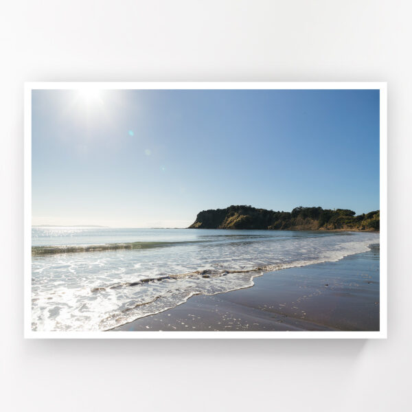 Small waves lap the shore at Army Bay Beach, Whangaparaoa